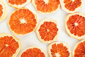 Dried round slices of grapefruit on a white background