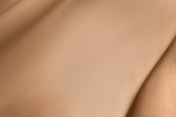 Luxury light brown beige color creased smooth satin silk cloth texture decorate background with minimalistic style and copy or negative space