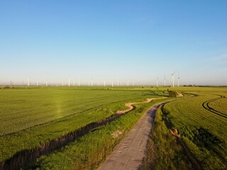 Aerial drone. Wind farm in the fields in south east England. Wind turbines near Camber Sands and Rye, East Sussex.