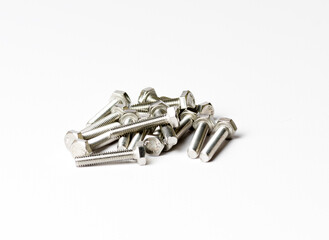 A handful of bolts with shiny metal threads on a white background side view