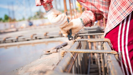 Construction workers fabricating steel reinforcement bar at the construction site. 