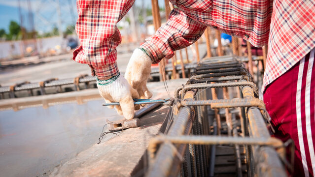 Construction workers fabricating steel reinforcement bar at the construction site. 
