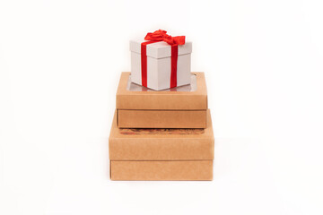 Mocap. A stack of three gift boxes led by a white box and a red bow.
