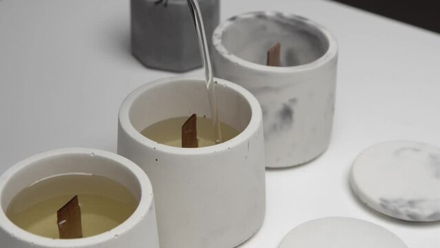 Concrete Candle Is Poured With Melted Wax