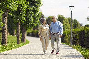 Staying in love is something very special. Cheerful senior couple having a good time in a city park...