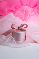 pink box with ribbon on pink background