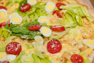 Close up of delicious hot pizza in cardboard box on light blue background. Selective focus.