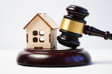 Wooden model of a house with a judge's gavel. The concept of judicial property cases.