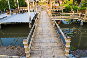 Walking suspense bridge made of dry bamboo in Thailand.