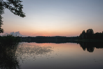 Fototapeta premium sunset on the river, twilight and a pink streak of sky