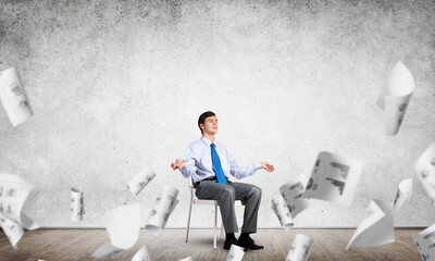 businessman meditates on office chair
