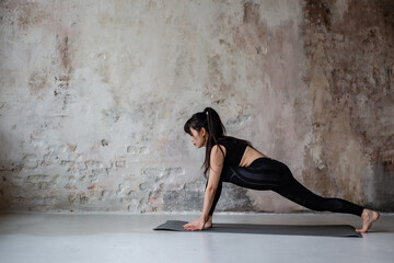 Fototapeta na wymiar cute Asian girl with dark long hair in workout sportswear resting after a workout