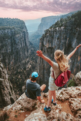 Couple on cliff Tazi canyon travel hiking together healthy lifestyle active summer vacations...
