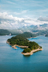 Fototapeta na wymiar Aerial view landscape Karacaoren lake surrounded by mountains in Turkey. Forest island in turquoise water scenery wild nature travel beautiful destinations