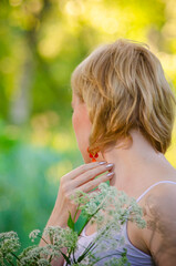 Portrait of a young girl walking in a beautiful summer park. Spring mood. Copy space.