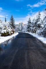 snow covered asphalt road and street in urban in February. Snowy and clear Weather. Selective Focus