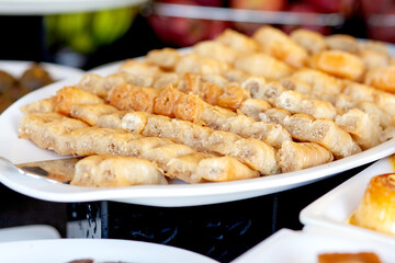 Baklava - is a layered pastry dessert made of filo pastry, filled with chopped nuts, and sweetened with syrup or honey.