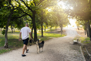 Anonymous man walking with dog