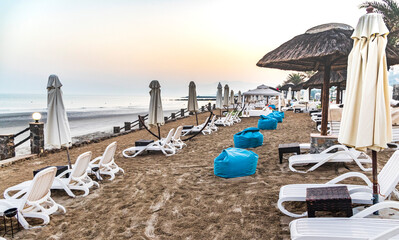 Sunbeds and beanbags by the beach. Outdoors