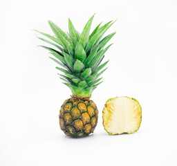 whole and slice pineapple with leaves isolated on white background