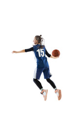 Portrait of young girl, basketball player in blue uniform training isolated over white studio background. Passing ball in a jump.