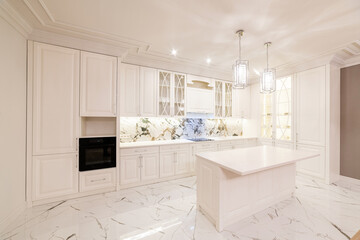 large fluffy clean kitchen in white with lights and appliances