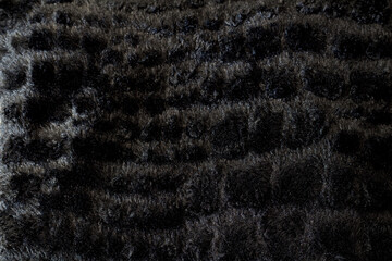 Texture of black soft fleece fluffy fabric.