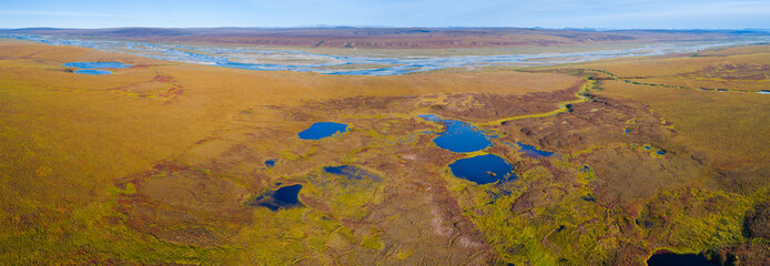 Aerial view of  tundra wetland of the North slope in Alaska with river and lakes in autumn colors
 - obrazy, fototapety, plakaty