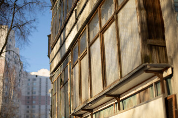 Old balcony in house. Wooden window frames. Building is in detail.