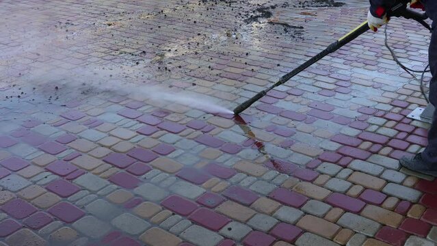 Cleaning backyard paving tiles with high pressure washer. Spring clean up. slow motion