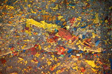 Fototapeta na wymiar Pieces of paint lie on asphalt. Texture of colored dirt.