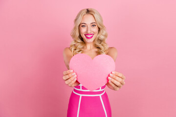 Fototapeta na wymiar Photo of positive romantic girlfriend demonstrate heart figure wear fancy striped dress isolated pink color background