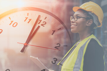 Engineer black smart woman worker in factory overlay with time clock for working hours concept.