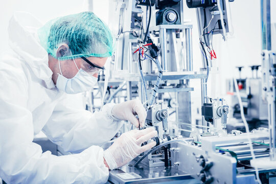 Science worker engineer service fix repair advance machine in medical equipment hygine factory.