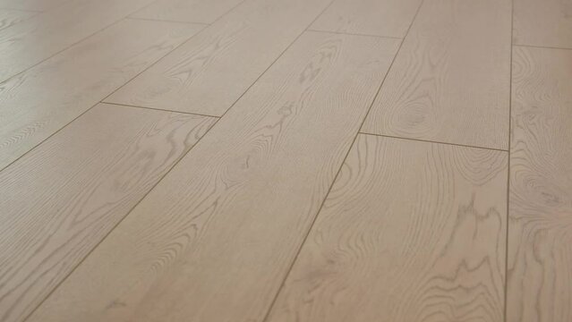 The floor is brown laminate in daylight close-up.