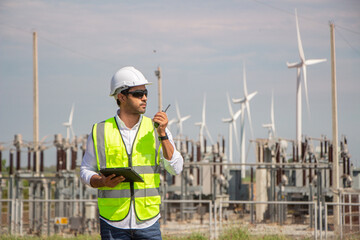 engineer team working in wind turbine farm. Renewable energy with wind generator by alternative energy concept.