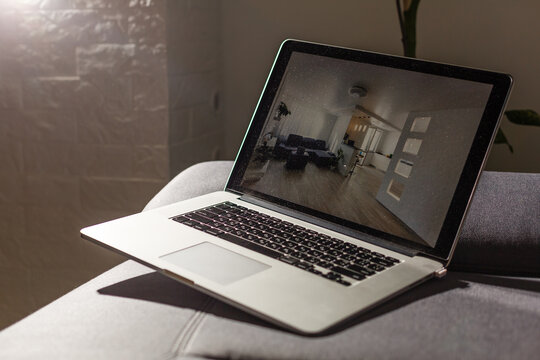 Laptop With News Website In Screen On Table In Business Office, Corporate Lounge Or Hotel Lobby. Company Wireless Wifi. Modern Cafe Or Workplace. Online Article In Computer. Woman On Chair Waiting..