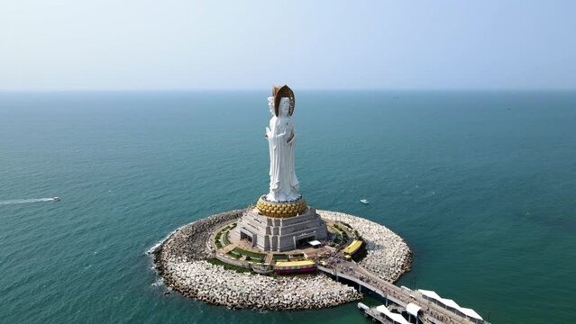 Aerial orbit shot drone footage of Guanyin of the South Sea statue of Nanshan Buddhism cultural park temple in Sanya Hainan island China