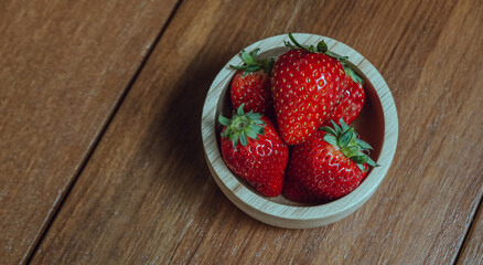 Fresh juicy premium strawberries on natural wooden background. Tochiotome Japanese strawberry.