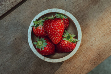 Fresh juicy premium strawberries on natural wooden background. Tochiotome Japanese strawberry.