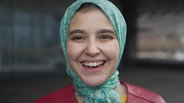 Happy Muslim girl smiling in camera