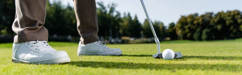 Stoff pro Meter cropped view of man in white sneakers playing golf on lawn, banner. © LIGHTFIELD STUDIOS