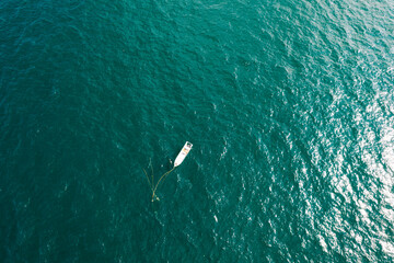 Obraz premium Aerial view of blue ocean and single boat