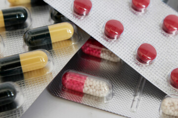 there are many different packages of blisters colorful tablets and capsules of medicines in close-up for treatment and prevention