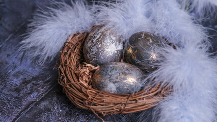 Easter card with a copy of the place for the text. Very Peri 2022 .Purple, blue eggs in a basket on a dark newspaper background. Natural dye karkade tea.