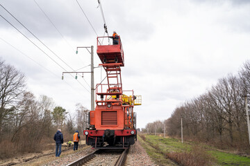 Repair of high-voltage wires for trains. Repair team of electricians restores electrical communication.