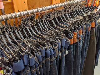 Lots of pants neatly arranged on the hanger
