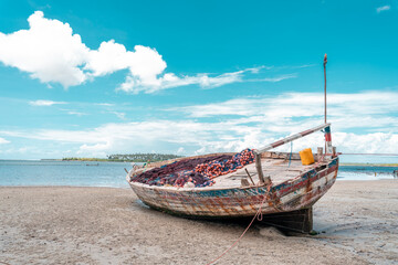 Pristine white tropical beach with rocks, blue sea and lush vegetation on the African Island of...