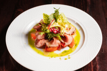 Salad with meat and vegetables. Fine dinning menu.