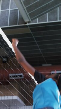 Female players playing volleyball in the court 4k